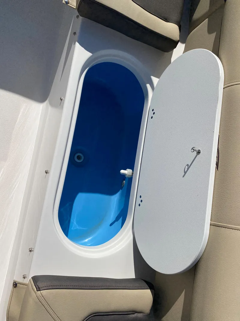 Slide: The Image of 2021 Tidewater 210 LXF boat with open livewell compartment. - 21