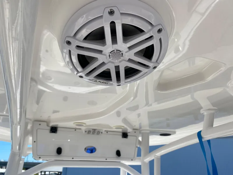 Slide: The Image of 2021 Tidewater 210 LXF boat with mounted marine speaker and overhead console. - 23