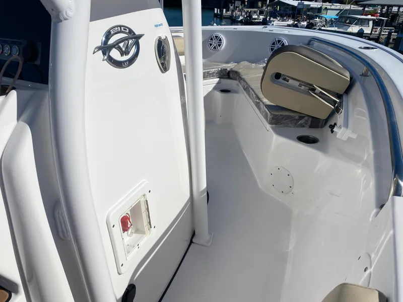 Slide: The Image of 2021 Tidewater 210 LXF boat interior, featuring white seating and modern design. - 24