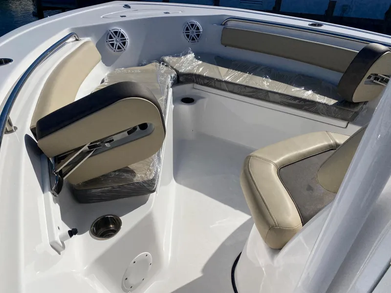 Slide: The Image of 2021 Tidewater 210 LXF boat interior with cushioned seating and cup holders. - 26