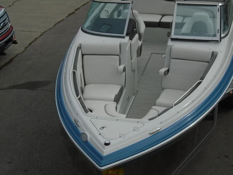 Slide: The Image of 2022 Crownline 240 SS boat with white and blue interior, front seating area. - 3