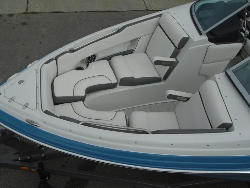 Slide: The Image of 2022 Crownline 240 SS boat interior with white and gray seating. - 4