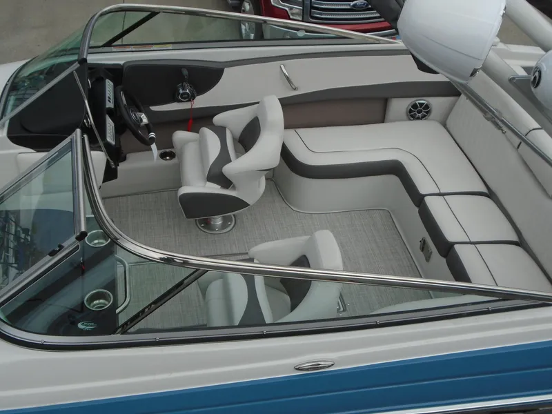 Slide: The Image of 2022 Crownline 240 SS boat interior with modern seating and steering wheel. - 5