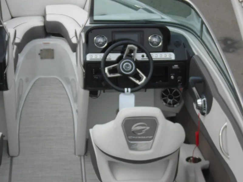Slide: The Image of 2022 Crownline 240 SS boat interior with steering wheel and dashboard. - 8