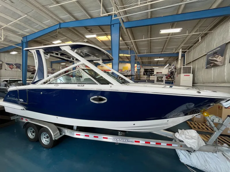 The Image of 2023 Chaparral 280 OSX boat on trailer in indoor showroom. - 0