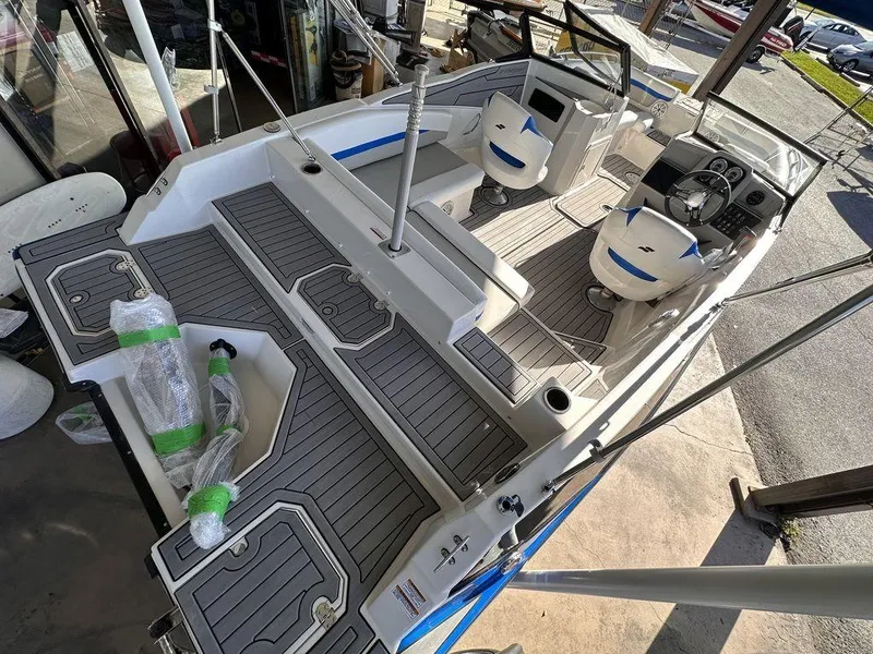 Slide: The Image of 2023 Starcraft SVX OB 210 OB DC boat interior with seating and deck view. - 3