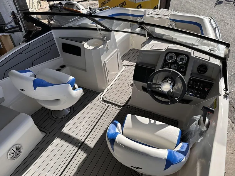 Slide: The Image of 2023 Starcraft SVX OB 210 OB DC boat interior with dual captain seats and modern dashboard. - 5