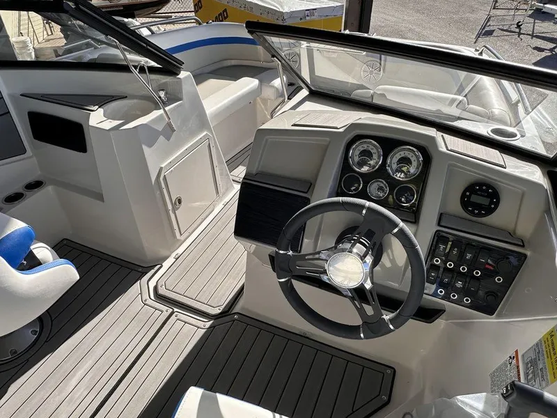 Slide: The Image of 2023 Starcraft SVX OB 210 OB DC boat interior with steering wheel and dashboard. - 7