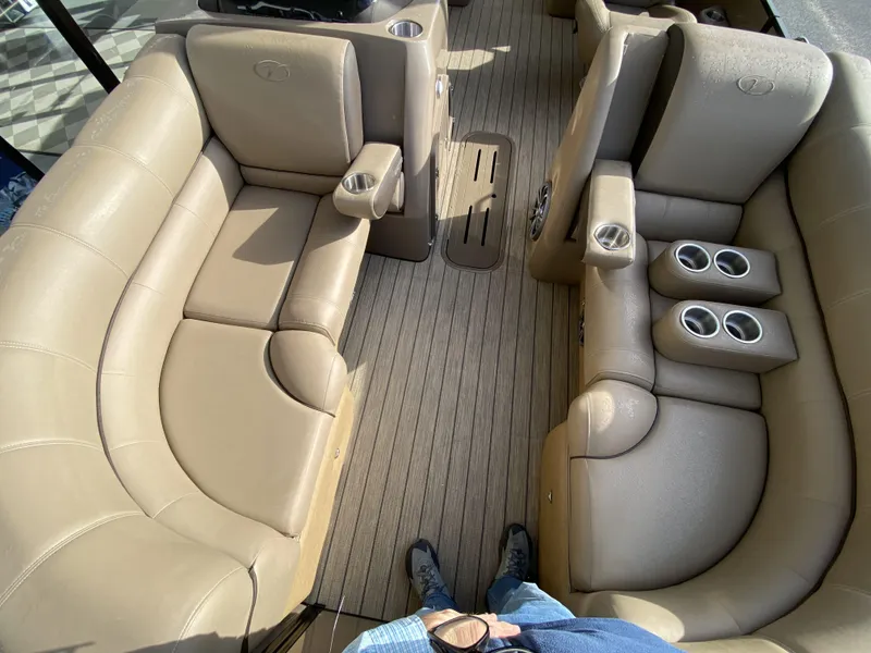 Slide: The Image of 2023 Veranda VTX 22RC boat interior with tan leather seating and cup holders. - 12