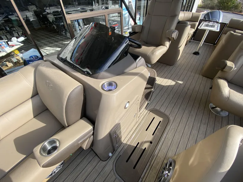 Slide: The Image of 2023 Veranda VTX 22RC boat interior with beige seating and helm station. - 13