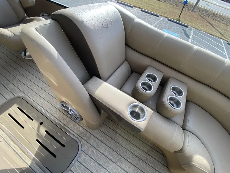 Slide: The Image of 2023 Veranda VTX 22RC boat interior with beige seating and cup holders. - 14
