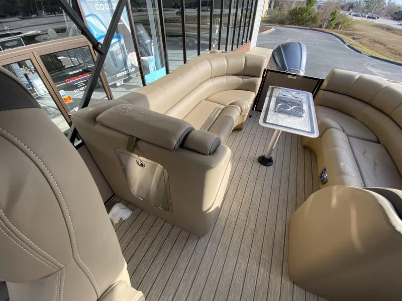 Slide: The Image of 2023 Veranda VTX 22RC pontoon boat interior with beige seating and table. - 19