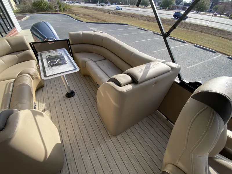 Slide: The Image of 2023 Veranda VTX 22RC boat interior with beige seating and a table. - 20