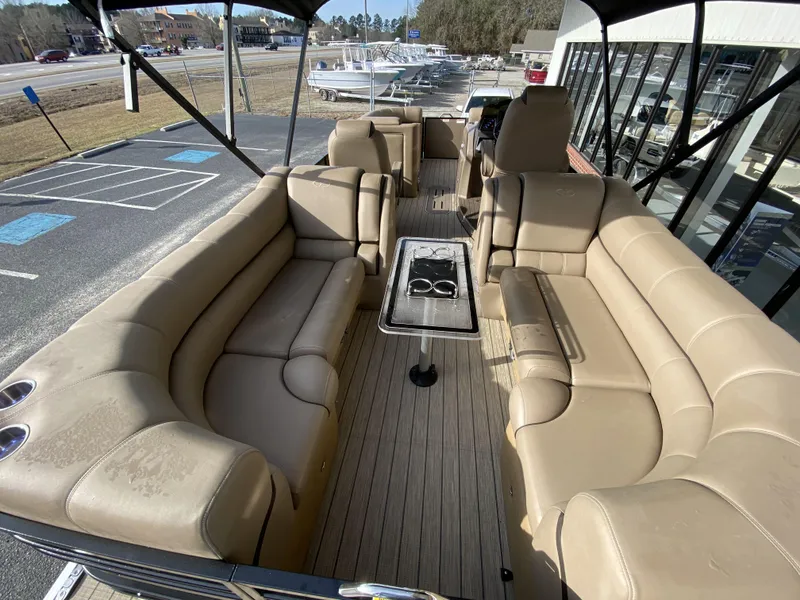Slide: The Image of 2023 Veranda VTX 22RC pontoon boat with beige seating and a central table. - 22