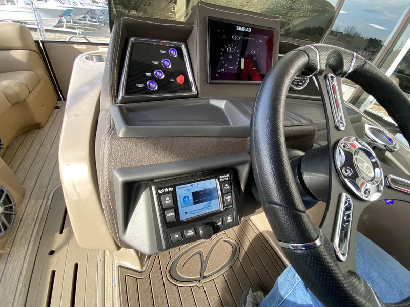 Slide: The Image of 2023 Veranda VTX 22RC boat dashboard with steering wheel and control panels. - 26