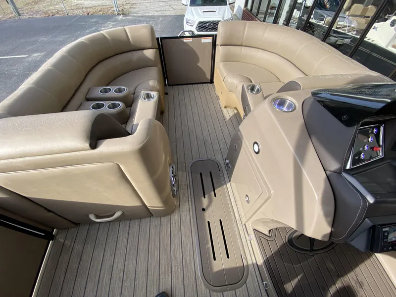 Slide: The Image of 2023 Veranda VTX 22RC pontoon boat interior with tan seating and cup holders. - 27