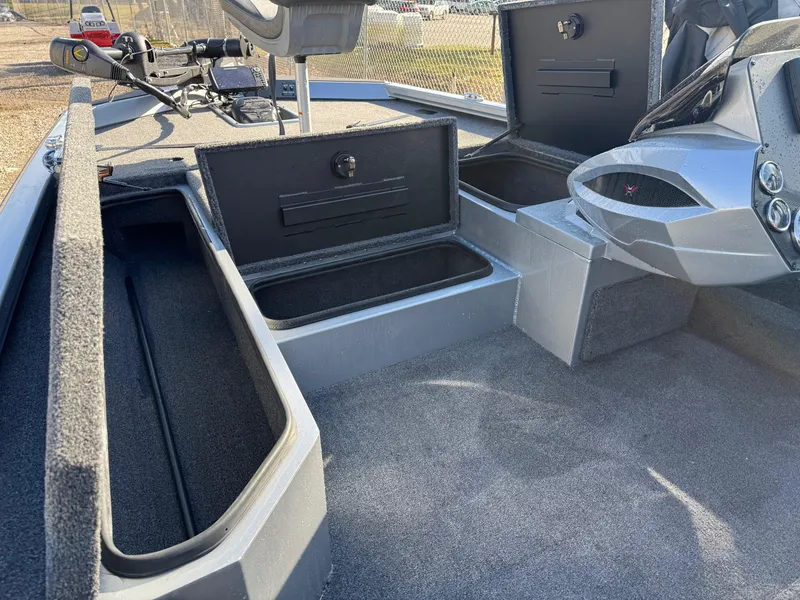 Slide: The Image of 2023 Vexus AVX181 boat interior with open storage compartments and steering console. - 18