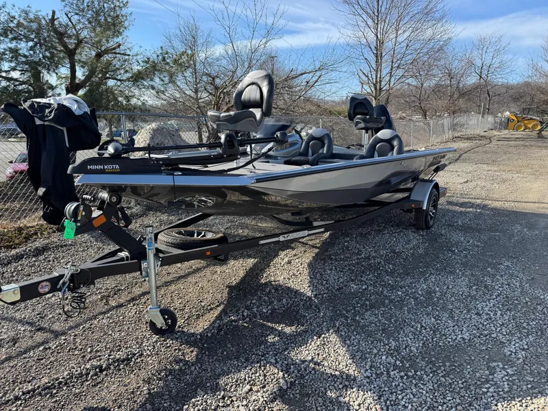 Slide: The Image of 2023 Vexus AVX181 boat on trailer, parked outdoors on gravel. - 2