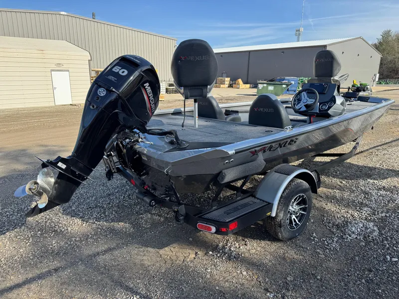 Slide: The Image of 2023 Vexus AVX181 boat with outboard motor, parked on gravel near industrial buildings. - 3