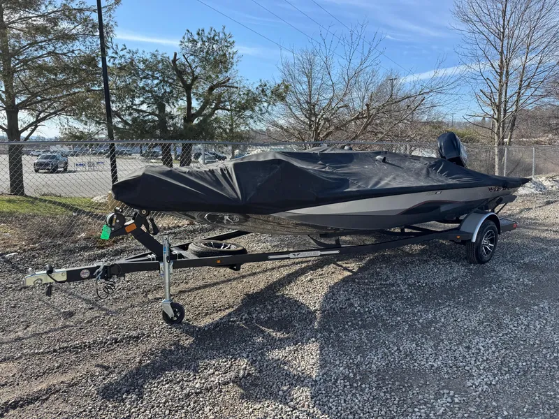 Slide: The Image of 2023 Vexus AVX181 boat covered on a trailer, parked outdoors. - 5