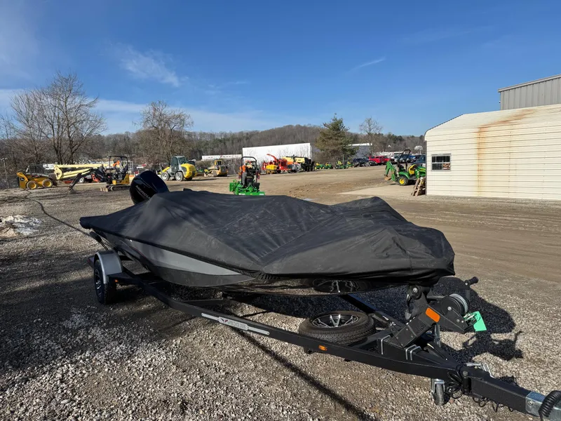 Slide: The Image of 2023 Vexus AVX181 boat covered, parked outdoors on gravel lot. - 6