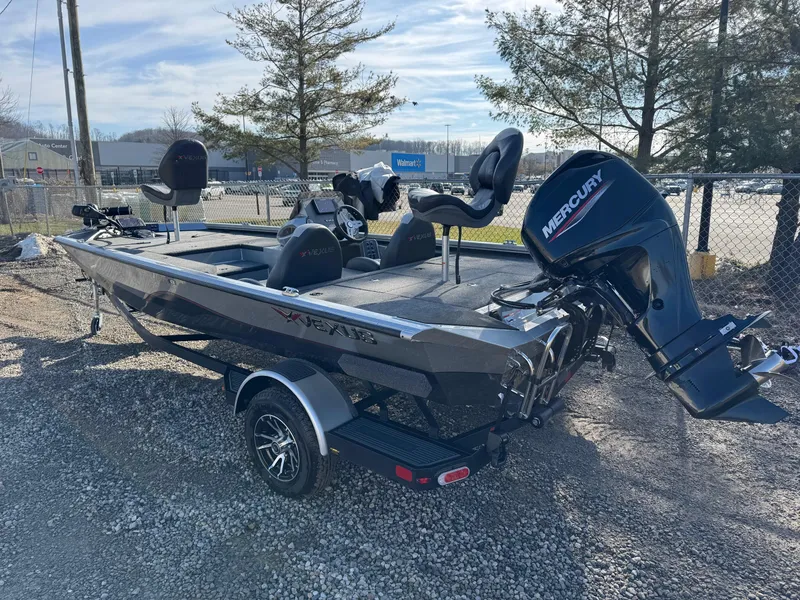Slide: The Image of 2023 Vexus AVX181 boat with Mercury engine, parked outdoors on gravel. - 8