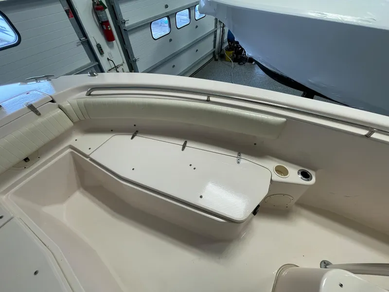 Slide: The Image of 2010 Grady-White 257 Advance boat interior with seating and storage in a garage. - 13