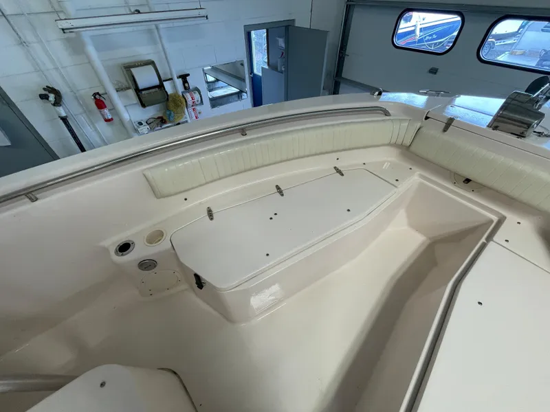 Slide: The Image of Interior view of a 2010 Grady-White 257 Advance boat, showcasing seating and storage. - 14