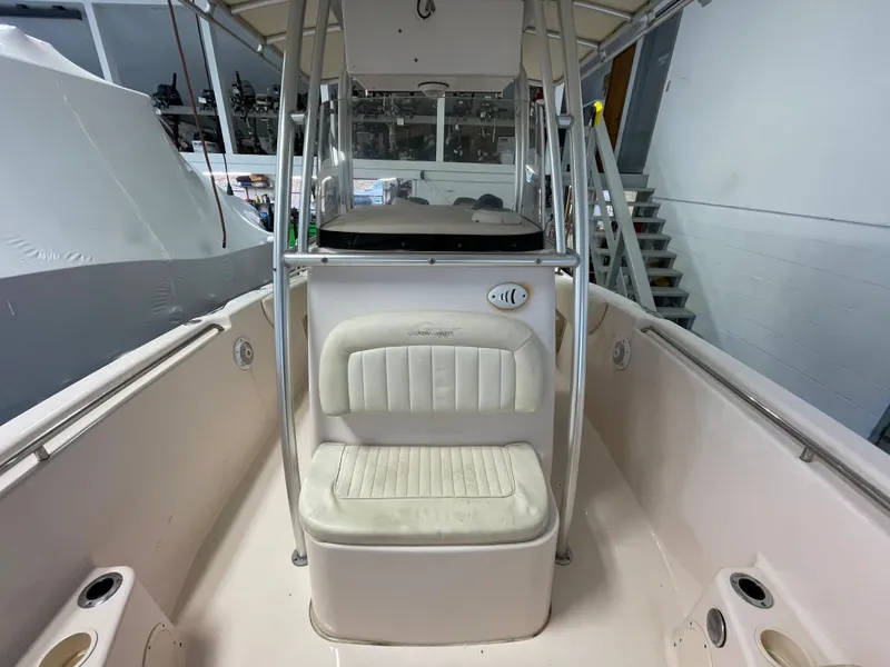Slide: The Image of 2010 Grady-White 257 Advance boat interior with seating and console in a storage facility. - 15