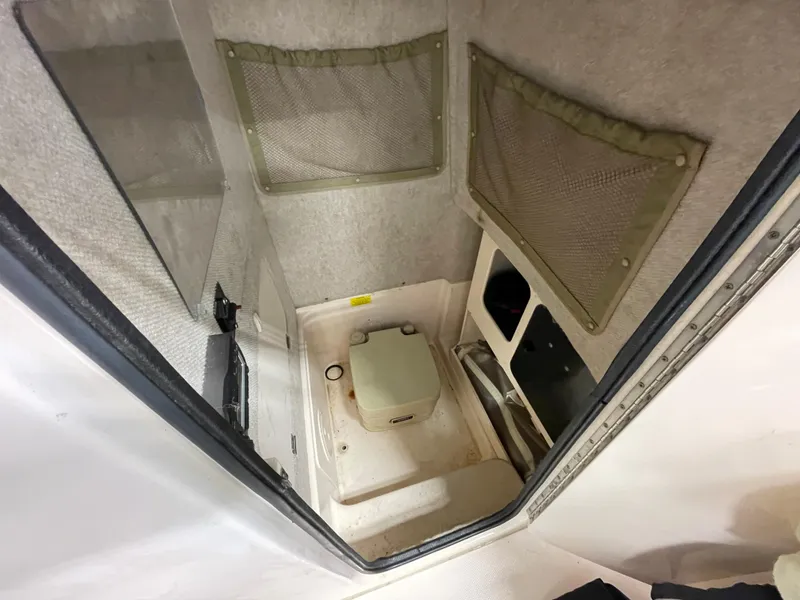 Slide: The Image of Interior cabin of 2010 Grady-White 257 Advance boat with storage compartments. - 18