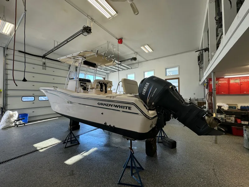 Slide: The Image of 2010 Grady-White 257 Advance boat in garage with Yamaha outboard motor. - 2