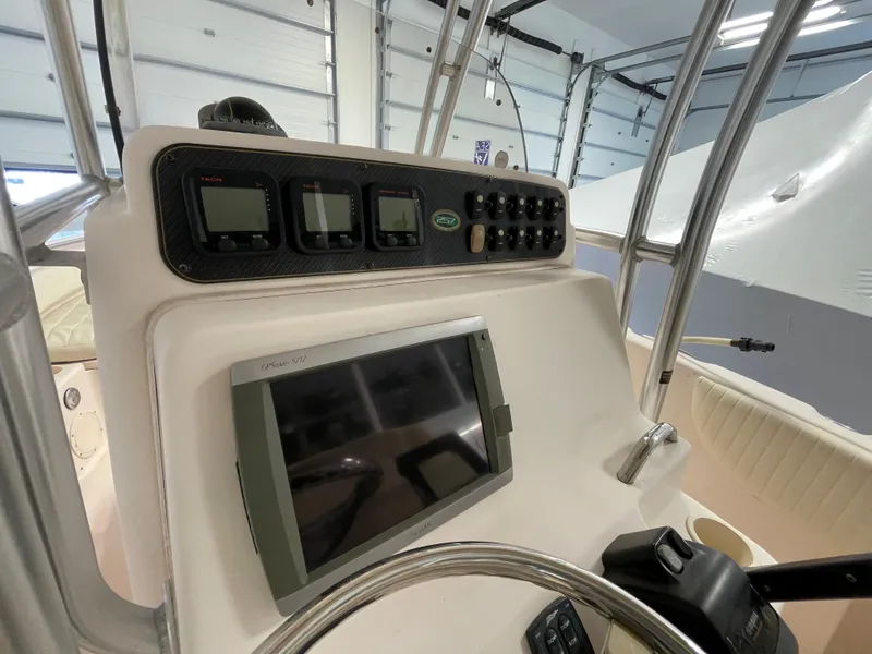 Slide: The Image of 2010 Grady-White 257 Advance boat dashboard with navigation controls and display. - 20