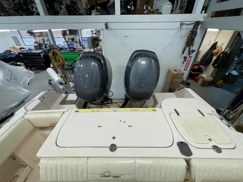 Slide: The Image of 2010 Grady-White 257 Advance boat with dual outboard motors in a workshop setting. - 21
