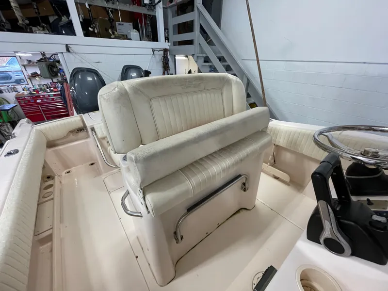 Slide: The Image of 2010 Grady-White 257 Advance boat interior with seating and steering wheel. - 23