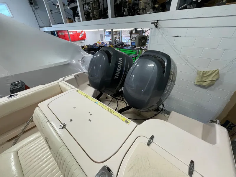 Slide: The Image of 2010 Grady-White 257 Advance boat with twin Yamaha outboard engines in a garage. - 26