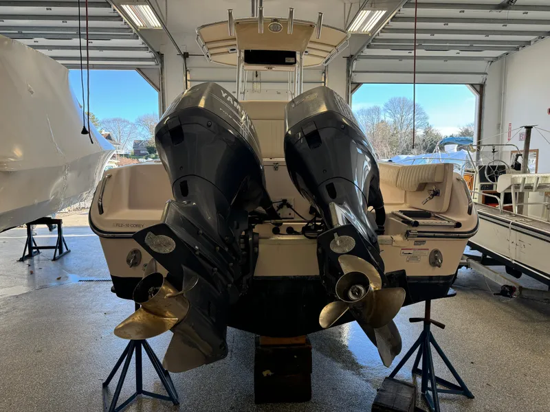 Slide: The Image of 2010 Grady-White 257 Advance boat with dual outboard motors in a garage. - 3