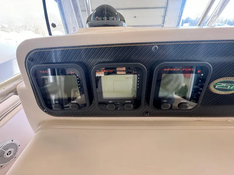 Slide: The Image of Grady-White 257 Advance 2010 boat dashboard with tachometer, speed, and fuel gauges. - 36