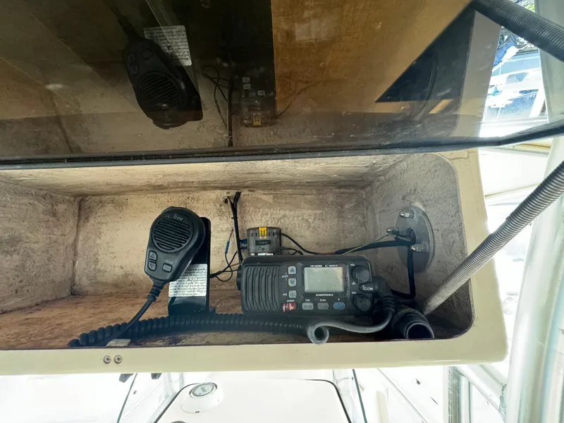 Slide: The Image of 2010 Grady-White 257 Advance boat radio and microphone setup in storage compartment. - 37