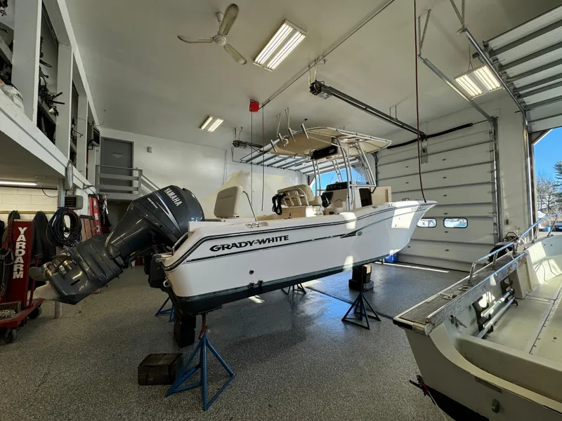 Slide: The Image of 2010 Grady-White 257 Advance boat in a garage, elevated on stands. - 4