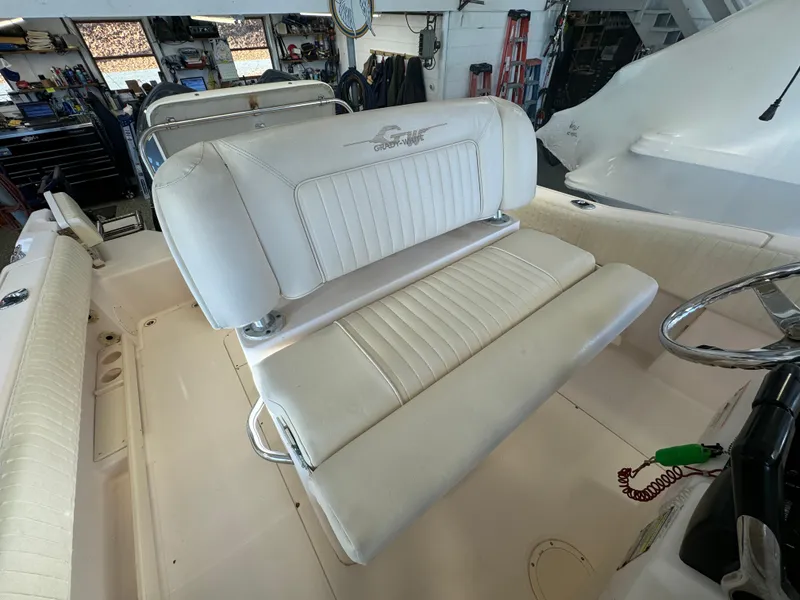 Slide: The Image of 2010 Grady-White 257 Advance boat interior with white seating and steering wheel. - 40