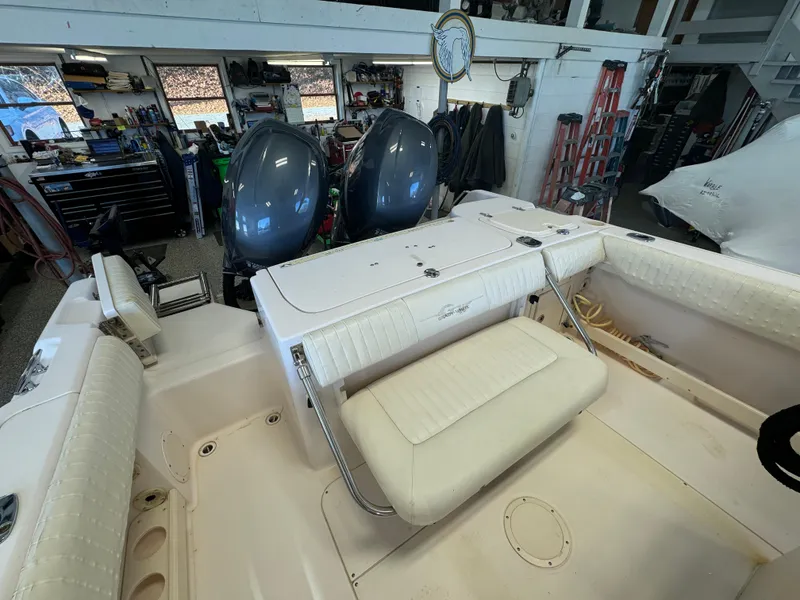 Slide: The Image of 2010 Grady-White 257 Advance boat interior with dual engines in a garage setting. - 41