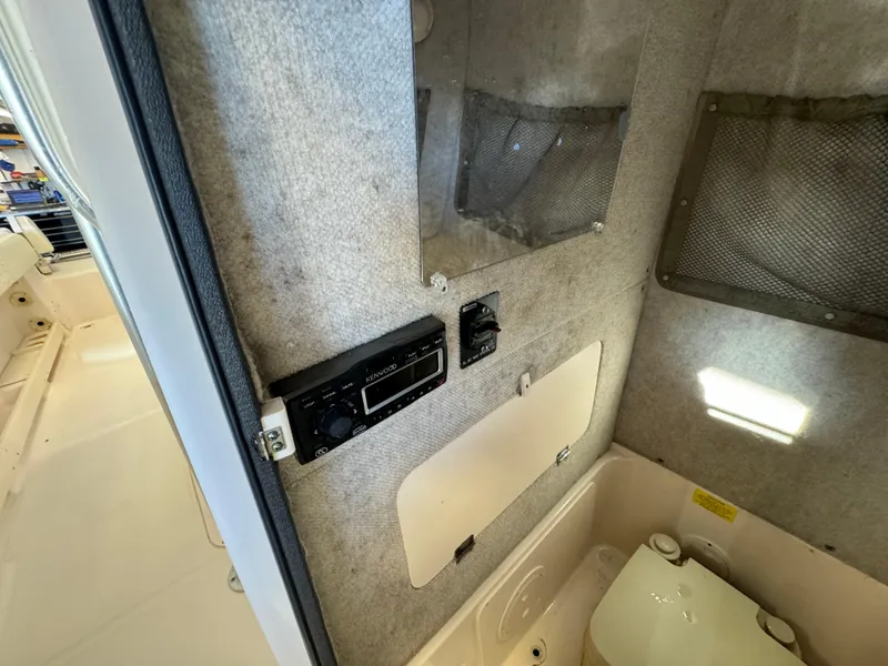 Slide: The Image of Interior cabin of 2010 Grady-White 257 Advance boat with control panel and storage. - 45