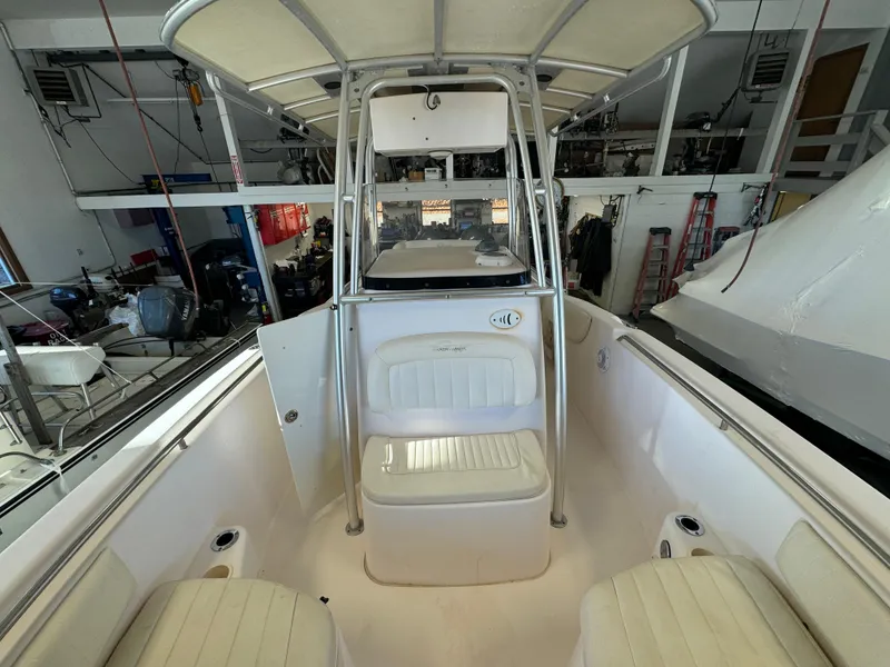 Slide: The Image of 2010 Grady-White 257 Advance boat interior with seating and console in a garage. - 48