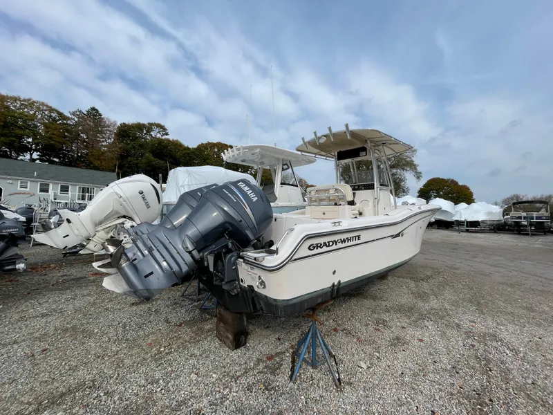 Slide: The Image of 2010 Grady-White 257 Advance boat with dual outboard motors on gravel lot. - 6