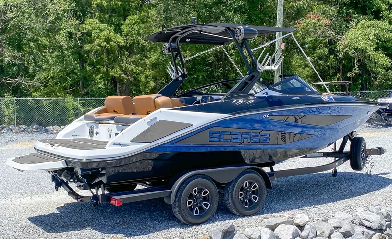 Slide: The Image of 2022 Scarab 215 ID Wake boat on a trailer, ready for water sports. - 19