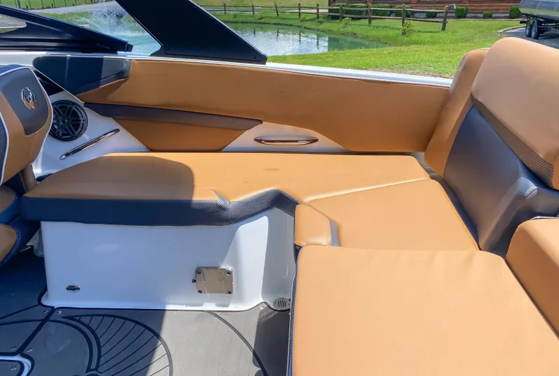 Slide: The Image of 2022 Scarab 215 ID Wake boat interior with tan and black seating. - 6