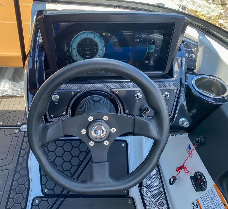 Slide: The Image of 2022 Scarab 215 ID Wake boat dashboard with steering wheel and digital display. - 8