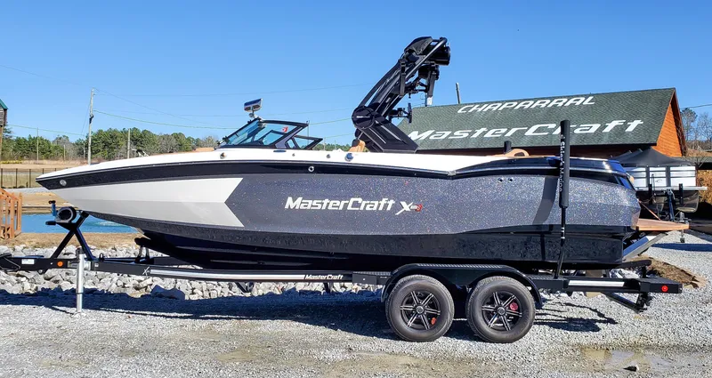 The Image of 2022 MasterCraft XStar boat on a trailer, side view. - 0
