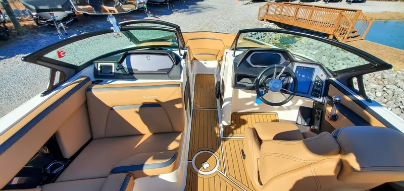 Slide: The Image of 2022 MasterCraft XStar boat interior with tan leather seats and modern dashboard. - 15
