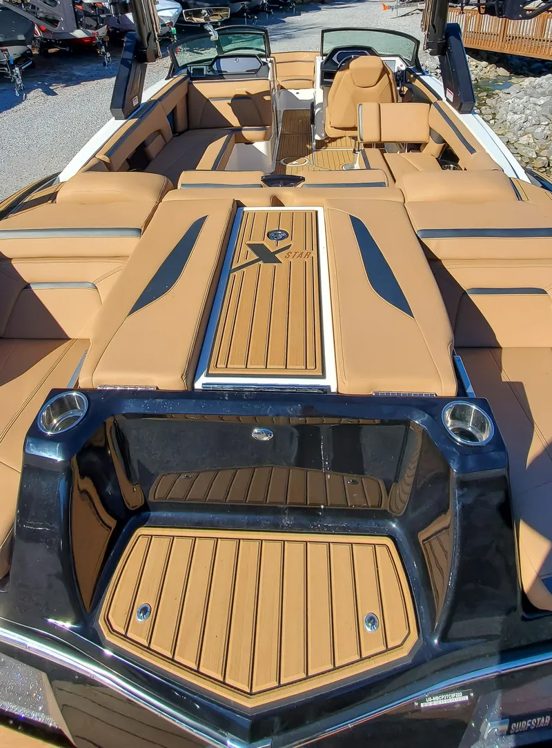 Slide: The Image of 2022 MasterCraft XStar boat with luxurious tan interior and sleek design. - 16